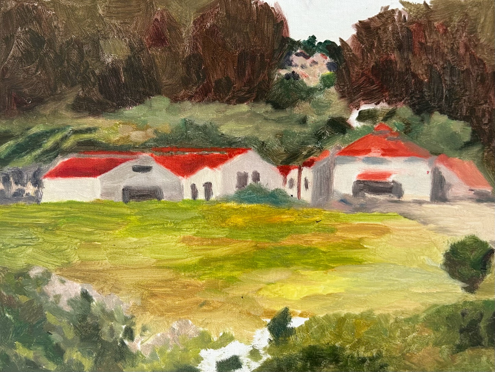 Plein air painting of red-roofed buildings below a dark treeline in the Presidio